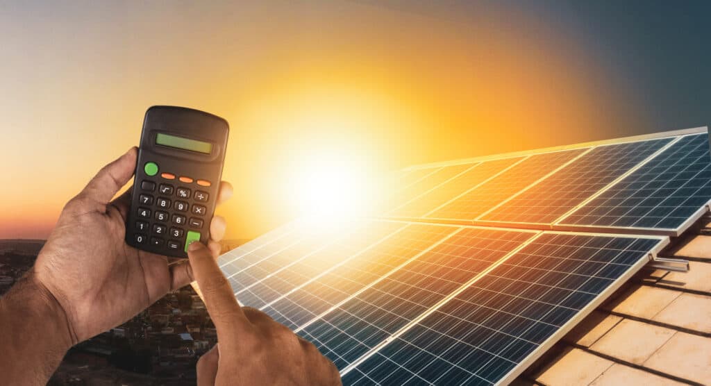 Man calculating his computer's power needs after learning that solar panels can power computers.