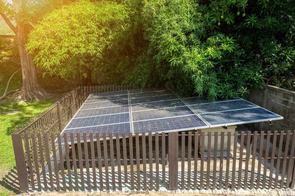 Panels installed under trees showing how solar panels can charge in the shade.