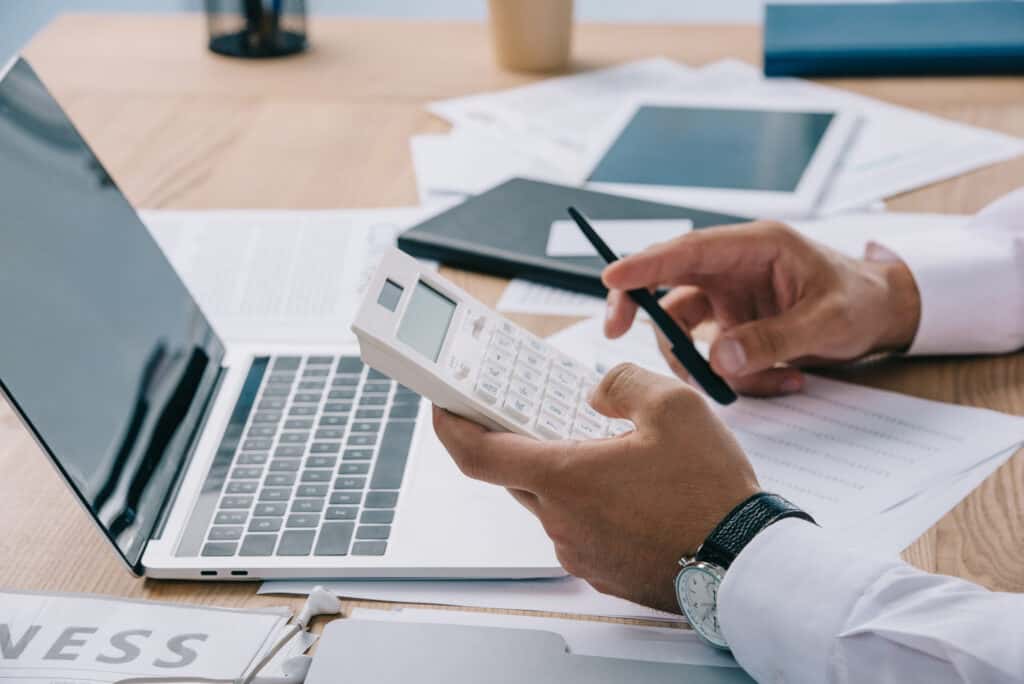 Man using solar calculator after finding the answer to "Do solar calculators have batteries?"