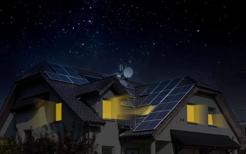 Solar panels on a roof at night powering a house.