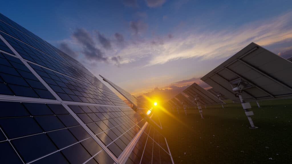 Solar panels at sunset answering the question of whether solar panels charge at night.